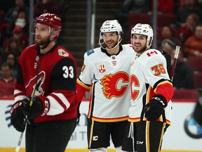 Flames Zac Rinaldo celebrates with Michael Frolik after scoring against the Arizona Coyotes in the second period at Gila River Arena on Tuesday, Dec. 10, 2019.