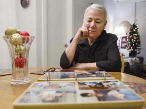 Jan Radford looks over baby photos of her twin adopted daughters in her Burnaby home on Dec. 20, 2019. Jan adopted the two orphans in the aftermath of the Romanian Revolution.