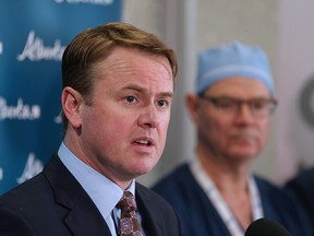 Alberta Health Minister Tyler Shandro makes an announcement on surgery wait times at the Southern Alberta Eye Centre on Tuesday, Dec. 10, 2019. Behind him stands medical director Dr. Geoff Williams.