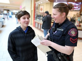 Cst. Christy Christen and Sam Fleming decide which stores to head to while shopping during the 14th Annual Copshop Event at Marlborough Mall on Wednesday, December 4, 2019.