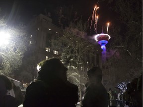 Hundreds of people watch fireworks off the top of the Calgary Tower during a New Year's Eve countdown ball and fireworks show in Olympic Plaza on Sunday, Dec. 31, 2017 and Monday, Jan. 1 2018 in Calgary, Alta. Britton Ledingham/Postmedia Network