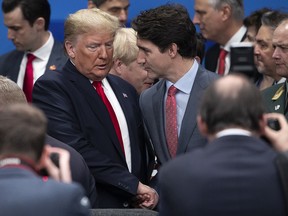 Prime Minister Justin Trudeau speaks to U.S. President Donald Trump at the NATO summit in Watford, England, on Dec. 4, 2019.