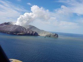 This handout photo taken and released on December 10, 2019 from the Auckland Rescue Helicopter Trust shows the view from a rescue helicopter as it heads toward the smoldering White Island volcano off the coast of New Zealand's North Island