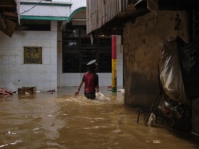 JAKARTA, INDONESIA - JANUARY 02: An Indonesian girl walks through a flooded neighborhood on January 2, 2020 in Jakarta, Indonesia. Flooding caused by heavy rain left at least 17 people dead and tens of thousands displaced from their homes as the city prepares for continued rains. (Photo by Ed Wray/Getty Images)