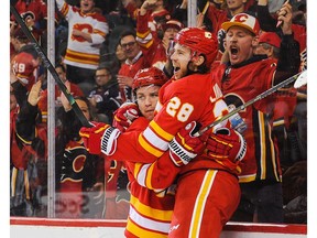 CALGARY, AB - JANUARY 11: Elias Lindholm #28 (R) of the Calgary Flames celebrates after scoring the game-winning goal against the Edmonton Oilers during an NHL game at Scotiabank Saddledome on January 11, 2020 in Calgary, Alberta, Canada.