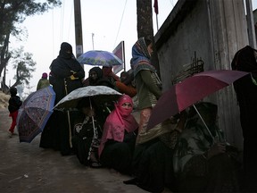 COX'S BAZAR, BANGLADESH - JANUARY 23: People wait for treatment outside a hospital in a Rohingya refugee camp  on January 23, 2020 in Cox's Bazar, Bangladesh. On Thursday, the International Court of Justice ordered Myanmar to take emergency measures to prevent genocide of the Rohingya. In a unanimously-ruled order  the court upheld the provisions of the 1948 Genocide Convention - saying Myanmar had "caused irreparable damage to the rights of the Rohingya". (Photo by Allison Joyce/Getty Images)