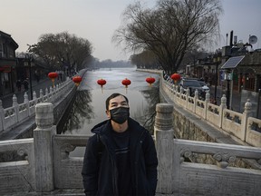 BEIJING, CHINA - JANUARY 26: A Chinese man wears a protective mask as he stands on a bridge at Houhai Lake, which would usually be crowded at this time, during the Chinese New Year and Spring Festival Holiday on January 26, 2020 in Beijing, China. The number of cases of a deadly new coronavirus rose to over 2000 in mainland China Sunday as health officials locked down the city of Wuhan earlier in the week in an effort to contain the spread of the pneumonia-like disease. Medical experts have confirmed the virus can be passed from human to human. In an unprecedented move, Chinese authorities put travel restrictions on the city, which is the epicenter of the virus, and neighboring municipalities affecting tens of millions of people. The number of those who have died from the virus in China climbed to at least 56 on Sunday, and cases have been reported in other countries including the United States, Canada, Australia, France, Thailand, Japan, Taiwan and South Korea. (Photo by Kevin Frayer/Getty Images)