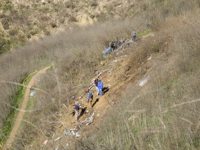 Investigators work at the scene of the helicopter crash that killed former NBA star Kobe Bryant and his 13-year-old daughter Gianna on January 27, 2020 in Calabasas, California.