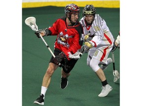 Roughnecks Shane Simpson cradles the ball with presser from Wings Steph Charbonneau during the 2nd half of NLL action as the Calgary Roughnecks lost to Philadelphia Wings 8-7 at the Saddledome on Saturday, December 28, 2019. Brendan Miller/Postmedia