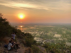Tonle Sap Lake and rice paddies shimmer in the setting sun, viewed high above. Photo, Theresa STorm