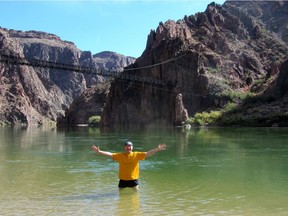 The Colorado River flows through the Grand Canyon, carving through rock as water has done for billions of years. The writer enjoys the cool water after a hike down in the brutal heat. Courtesy, Marina Nelson