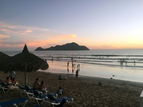 Swimmers enjoy the sunset at the beach adjacent to the El Cid El Moro Beach Hotel. Photo, Jon Roe.