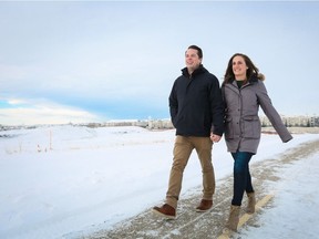 Colin and Stephanie Piggot take a stroll past their lot in Arbour Lake West.
