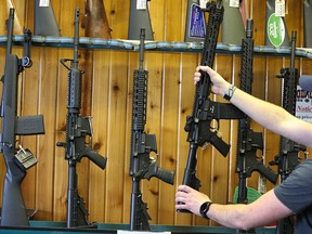 Semi-automatic AR-15's for sale at Good Guys Guns and Range in Orem, Utah. Semi-automatic rifles fill a wall at a gun shop in Lynnwood, Wash. The Canadian federal government has announced a ban on the use and sale of assault-style guns.