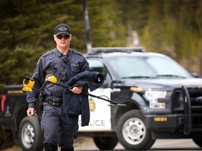 In this May 2019 file photo, Calgary police investigate after the discovery of two bodies west of the city. The deaths of Jasmine Lovett and and her 22-month-old daughter, Aliyah Sanderson, whose bodies were found in the woods off Hwy 40 in Kananaskis Country, were among 20 confirmed homicides in Calgary in 2019.