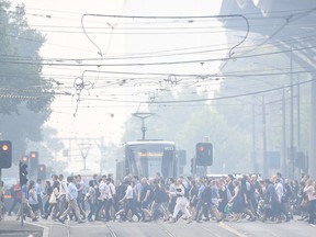 Morning commuters are seen through smoke haze from bushfires in Melbourne, Australia, January 14, 2020.    AAP Image/Erik Anderson/via REUTERS