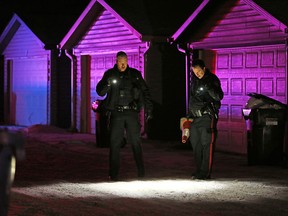 Police search an alley behind the 200 block of Saddlecrest Blvd N.E. after a fatal shooting on Saturday evening January 4, 2019.