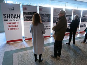Visitors read about the Holocaust at the City of Calgary’s first International Holocaust Remembrance Day ceremony at City Hall on Monday, January 27, 2020. Gavin Young/Postmedia