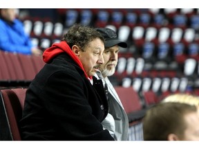 Guy Gaudreau (front in black coat), Flames forward Johnny Gaudreau's father, watches practice with Sam Bennett's dad David. Flames players and their fathers are getting together for the team's annual Dad's trip that will see them travel to Minnesota and Chicago with the team. Friday, January 3, 2020. Dean Pilling/Postmedia
