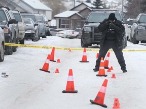 Calgary Police Crime Scene Unit member documents the scene on Somerside Close SW in Calgary on Sunday, January 12, 2020. At approximately 3:15 a.m., police received multiple calls of shots fired at the 100 block of Somerside Close S.W. and police found a home had been damaged by gunfire. There were no injuries. According to police, suspects had fled the scene. Jim Wells/Postmedia