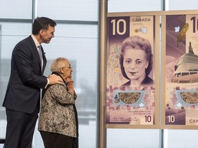 Wanda Robson, second from left, sister of Viola Desmond, admire the new $10 bank note featuring Desmond with Finance Minister Bill Morneau during a press conference in Halifax on Thursday, March 8, 2018. Desmond is the first Canadian woman to be featured on a regularly circulating bank note.