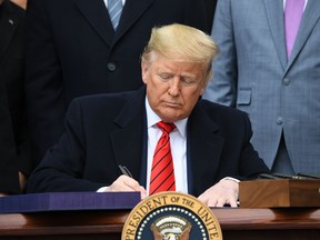 U.S. President Donald Trump signs the United States - Mexico -Canada Trade Agreement, known as USMCA, during a ceremony on the South Lawn of the White House in Washington, D.C., January 29, 2020.