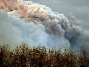 A plume of smoke from a wildfire near Fort McMurray Alberta is lit up at sunset on May 4, 2016. (PHOTO BY LARRY WONG/POSTMEDIA NETWORK)