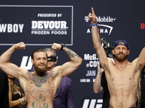 Welterweight fighters Conor McGregor, left, and Donald Cerrone pose during a ceremonial weigh-in for UFC 246 at Park Theater at Park MGM on Jan. 17, 2020 in Las Vegas, Nevada. (Steve Marcus/Getty Images)