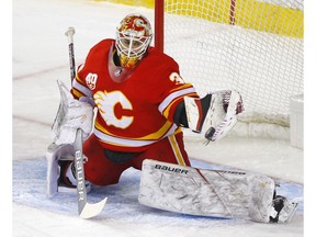 Calgary Flames goalie Cam Talbot makes a glove save on a Minnesota Wild shot in first-period action at the Scotiabank Saddledome in Calgary on Thursday. Photo by Darren Makowichuk/Postmedia.
