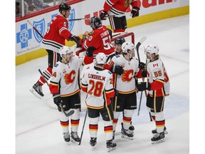 Jan 7, 2020; Chicago, Illinois, USA; Calgary Flames center Elias Lindholm (28) celebrates with teammates after scoring against the Chicago Blackhawks during the second period at United Center. Mandatory Credit: Kamil Krzaczynski-USA TODAY Sports ORG XMIT: USATSI-405665
