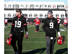 Calgary Stampeders quarterbacks Bo Levi Mitchell () and Nick Arbuckle walk off the McMahon Stadium turf after a closed practice in Calgary on Wednesday, October 30, 2019. Jim Wells/Postmedia