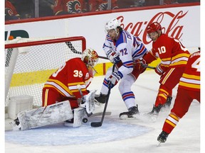 Calgary Flames goalie Cam Talbot stops New York Rangers Filip Chytil in second period action at the Scotiabank Saddledome in Calgary on Thursday, January 2, 2020. Darren Makowichuk/Postmedia