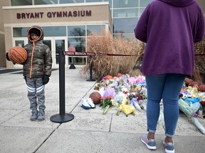 People pay their respects outside Bryant Gymnasium at Lower Merion High School, where basketball legend Kobe Bryant formally attended school, after his death, on Jan. 27, 2020 in Philadelphia.