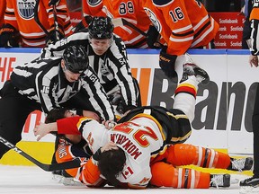 Oilers forward Ryan Nugent-Hopkins fights Flames forward Sean Monahan during the first period at Rogers Place on Wednesday, Jan. 29, 2020.
