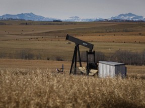 A de-commissioned pumpjack is shown at a well head on an oil and gas installation near Cremona, Alta., Saturday, Oct. 29, 2016. The group tasked with cleaning up Alberta's thousands of abandoned energy facilities says the province's rules for ensuring polluters clean up their wells before selling them off are "inadequate."
