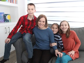 Sarah Bieber poses for a photo in her SW home with her children Kai, Cora and Halle. Bieber is the spokeswoman for Kids Come First, a parent group whom is frustrated with the vague report cards given by the CBE to students in elementary and junior high school. Friday, January 17, 2020. Brendan Miller/Postmedia