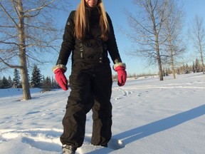 An image of a woman snowshoeing behind the Kerry Wood Nature Centre in the Gaetz Lakes Sanctuary in Red Deer, Alberta.