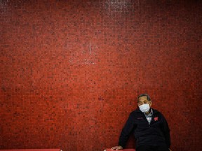 A man wears a face mask as he waits for a metro train during a Lunar New Year of the Rat public holiday in Hong Kong on January 27, 2020.