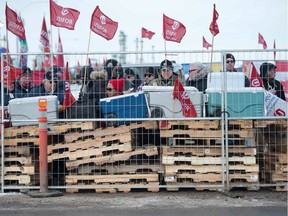 REGINA, SASK : February 1, 2020  -- Following a breakdown in bargaining, Unifor picket line barricades were rebuilt outside the Co-op Refinery Complex at Gate 7 on Fleet Street in Regina, Saskatchewan on Feb. 1, 2020. Pickets are shown here collecting lunch from coolers stored inside the barricade.