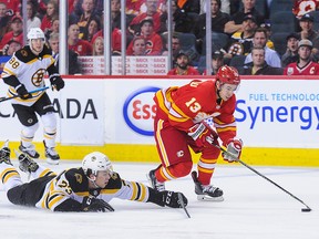 Johnny Gaudreau of the Calgary Flames carries the puck past Charlie McAvoy of the Boston Bruins during an NHL game at Scotiabank Saddledome on October 17, 2018 in Calgary, Alberta, Canada. (Photo by Derek Leung/Getty Images)