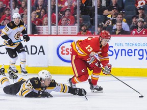 CALGARY, AB - OCTOBER 17: Johnny Gaudreau #13 of the Calgary Flames carries the puck past Charlie McAvoy #73 of the Boston Bruins during an NHL game at Scotiabank Saddledome on October 17, 2018 in Calgary, Alberta, Canada. (Photo by Derek Leung/Getty Images)