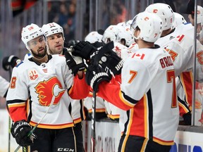 Oliver Kylington #58 of the Calgary Flames is congratulated at the bench after scoring a goal during the first period of Thursday night's game against the Anaheim Ducks at Honda Center on February 13, 2020, in Los Angeles, California.