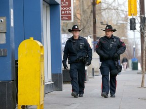 Calgary police Const. Brennan Martin (left) and Sgt. Gene Newcombe patrol the area around the Sheldon M. Chumir Health Centre in Calgary on Jan. 29, 2020.