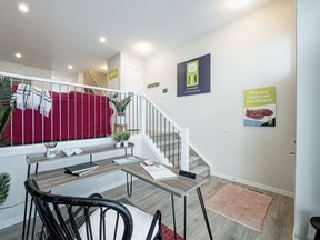 The work space at the front of the home is separated from the living room and the rest of home by a few steps in the Artist show home, by Avalon Master Builder at Zen Chinook Gate.