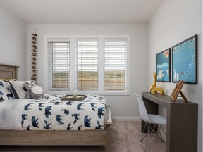 A secondary bedroom in the Emery by NuVista Homes in Sirocco.
