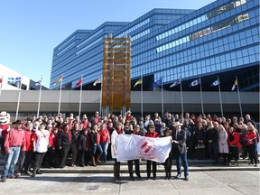 Kinsmen members hold a ceremonial flag during a Centennial flag raising at Calgary City Hall in honour of Kin Canada's 100th anniversary on Thursday, February 20, 2020. Jim Wells/Postmedia