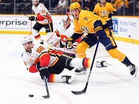 Feb 27, 2020; Nashville, Tennessee, USA; Calgary Flames defenseman Erik Gustafsson (56) falls to the ice trying to get away from Nashville Predators center Kyle Turris (8) during the first period at Bridgestone Arena. Mandatory Credit: Christopher Hanewinckel-USA TODAY Sports ORG XMIT: USATSI-405984