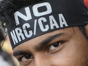 A demonstrator wearing a headband reading 'NO NRC/CAA' looks on during a protest against the Indian government's Citizenship Amendment Act (CAA) and the National Register of Citizens (NRC) at Jaffrabad area in New Delhi on February 23, 2020. (Photo by Sajjad HUSSAIN / AFP) (Photo by SAJJAD HUSSAIN/AFP via Getty Images)