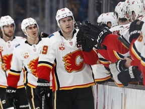 Calgary Flames Matthew Tkachuk (19) is congratulated at the bench after scoring against the Boston Bruins in the first period at TD Garden on Tuesday, Feb. 25, 2020.