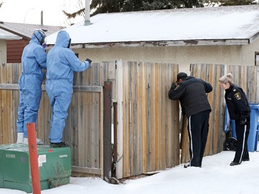 Police and bylaw officers prepare to remove about 25 dogs from a home on Malvern Crescent N.E. on Thursday February 13, 2020.